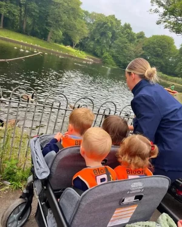 bloom childcare children and practitioner by water