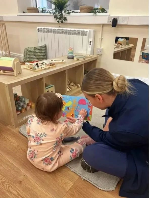 bloom childcare practitioner engaging with child during play