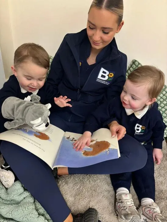 bloom childcare practitioner reading book with children