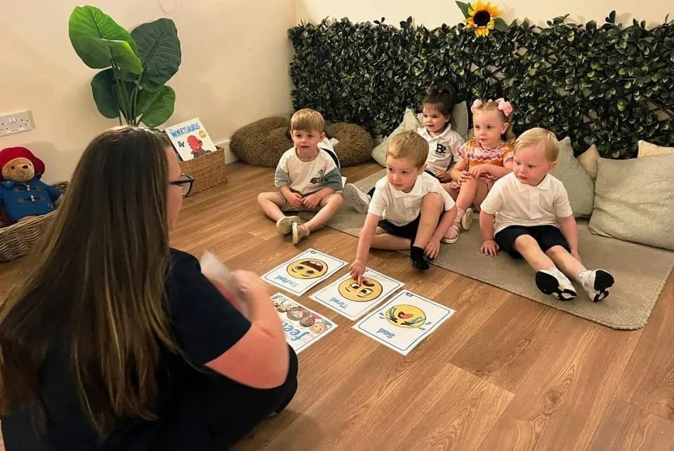 bloom childcare practitioners teaching children with flash cards